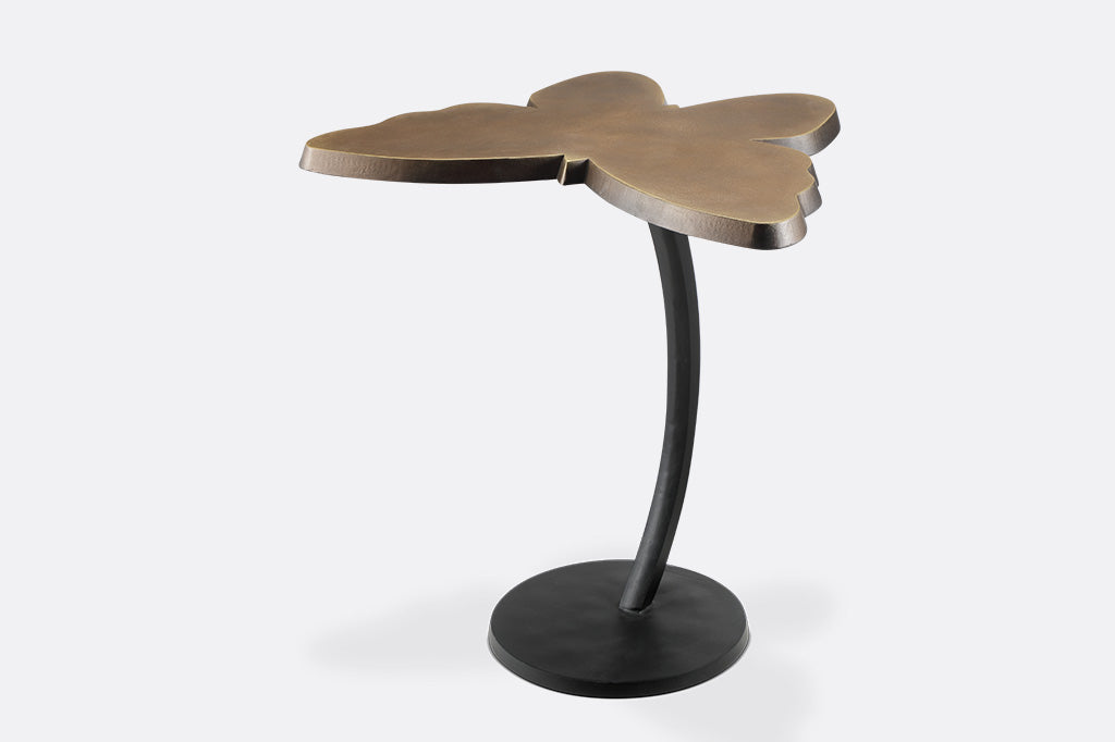 accent table with a striking bronze butterfly silhouette