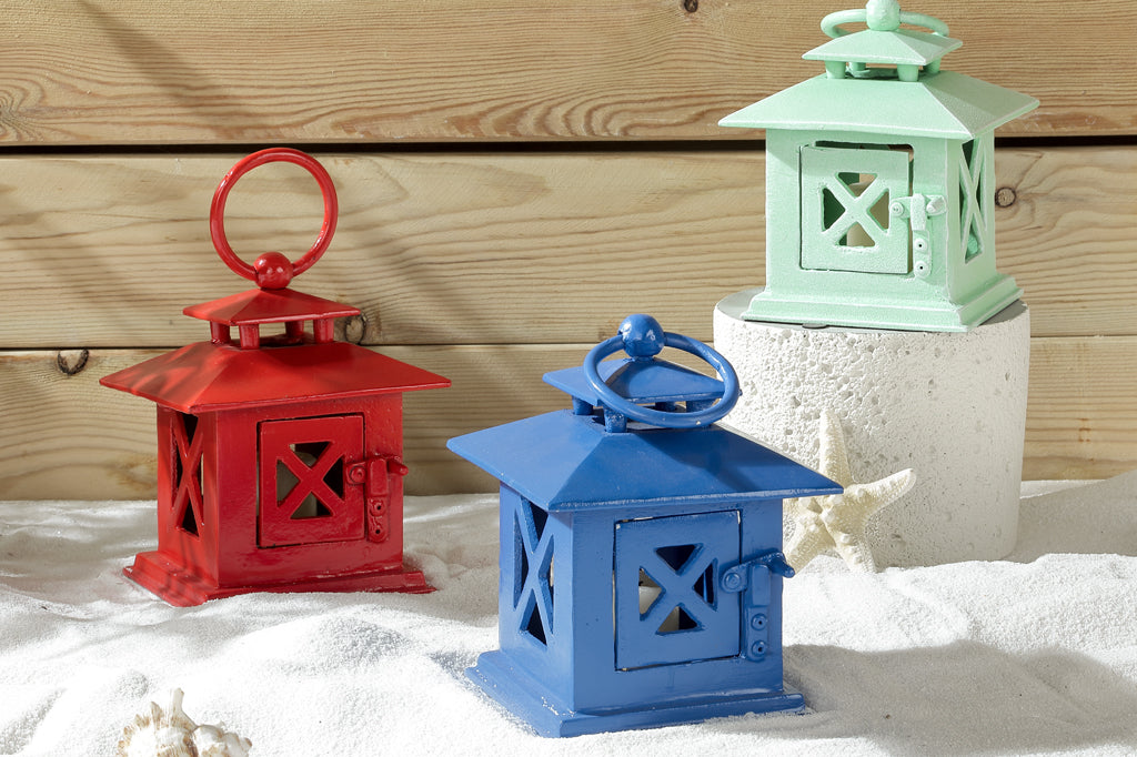cast metal lanterns on sand in Red Blue and Green #color_green #color_blue #color_red