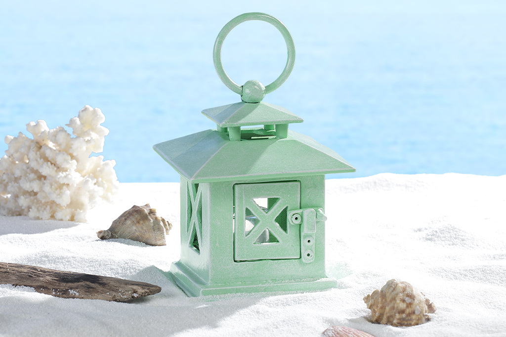 cast metal lantern in mint on sand #color_green