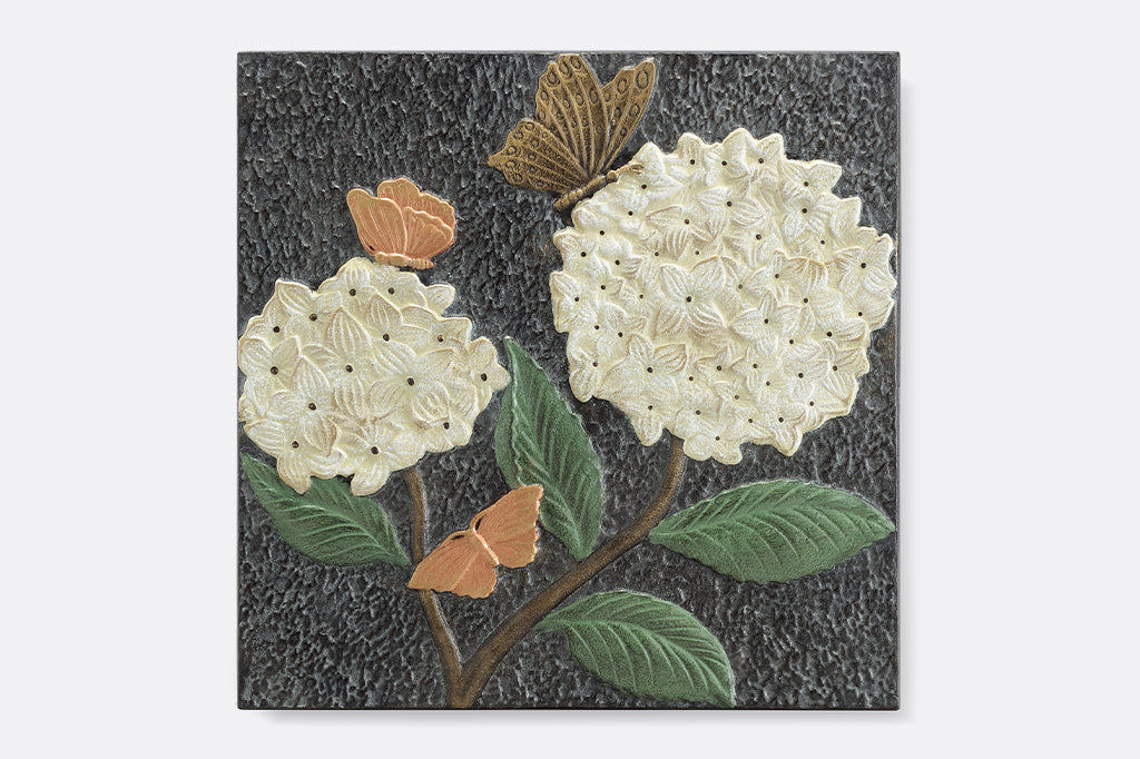 Cast aluminum stepping stone, two white puffball hydrangea with bronze and copper colored butterflies