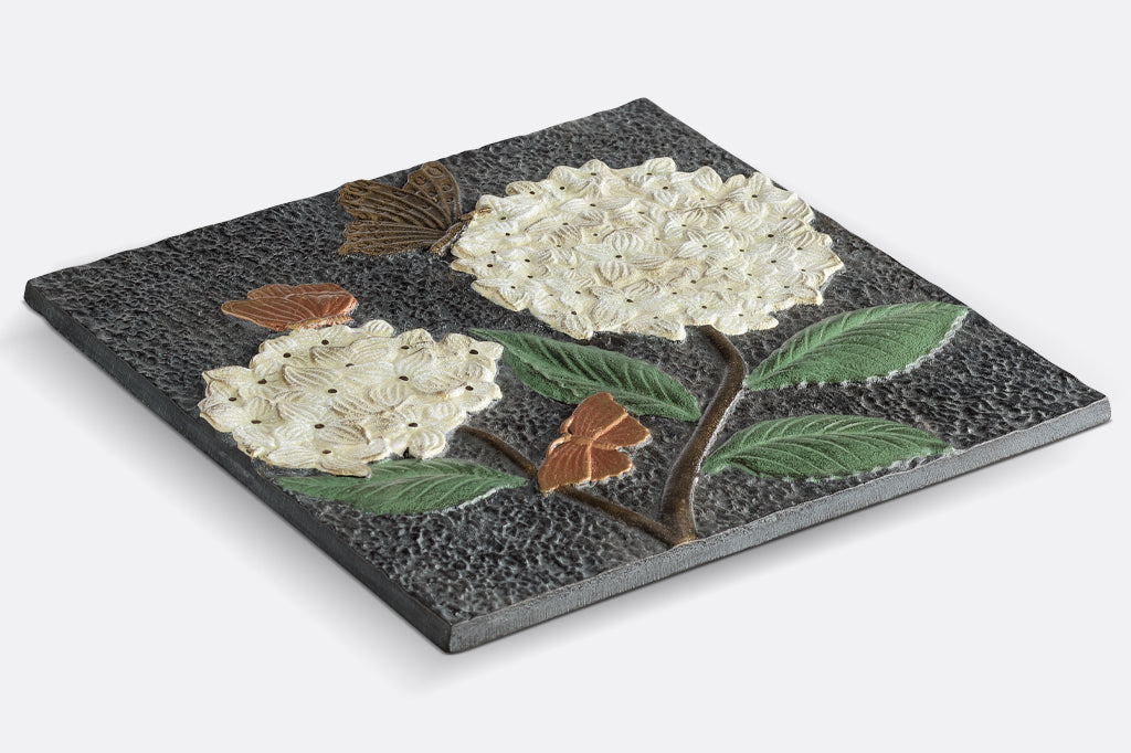 Cast aluminum stepping stone, two white puffball hydrangea with bronze and copper colored butterflies