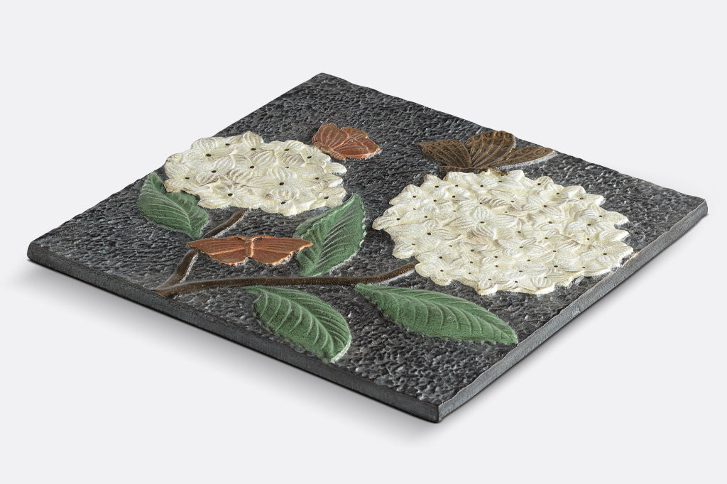 Cast aluminum stepping stone, two white puffball hydrangea with bronze and copper colored butterflies