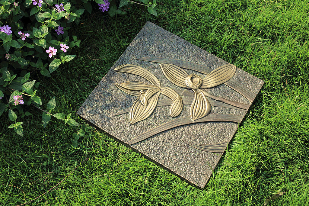 cast aluminum double orchid bloom garden stepping stone set on grass in garden
