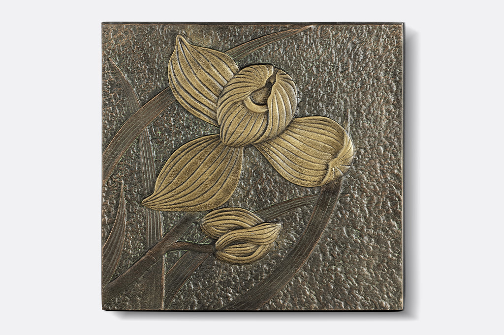 Cast metal stepping stone of orchid with two buds