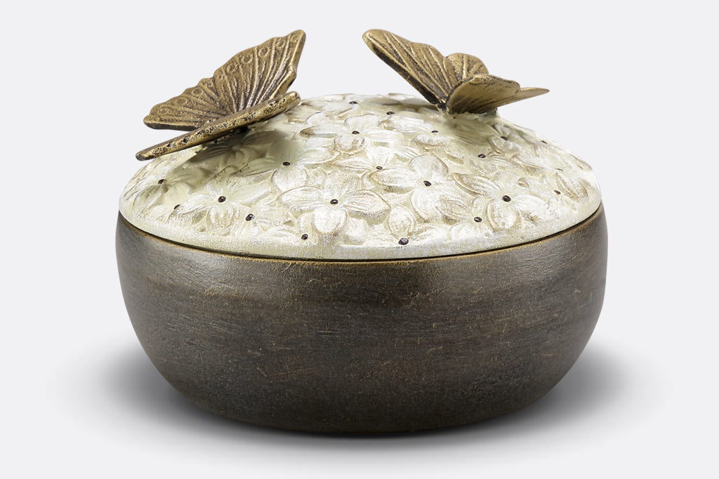 hydrangea box with floral pattern on lid and two bronze butterflies on top
