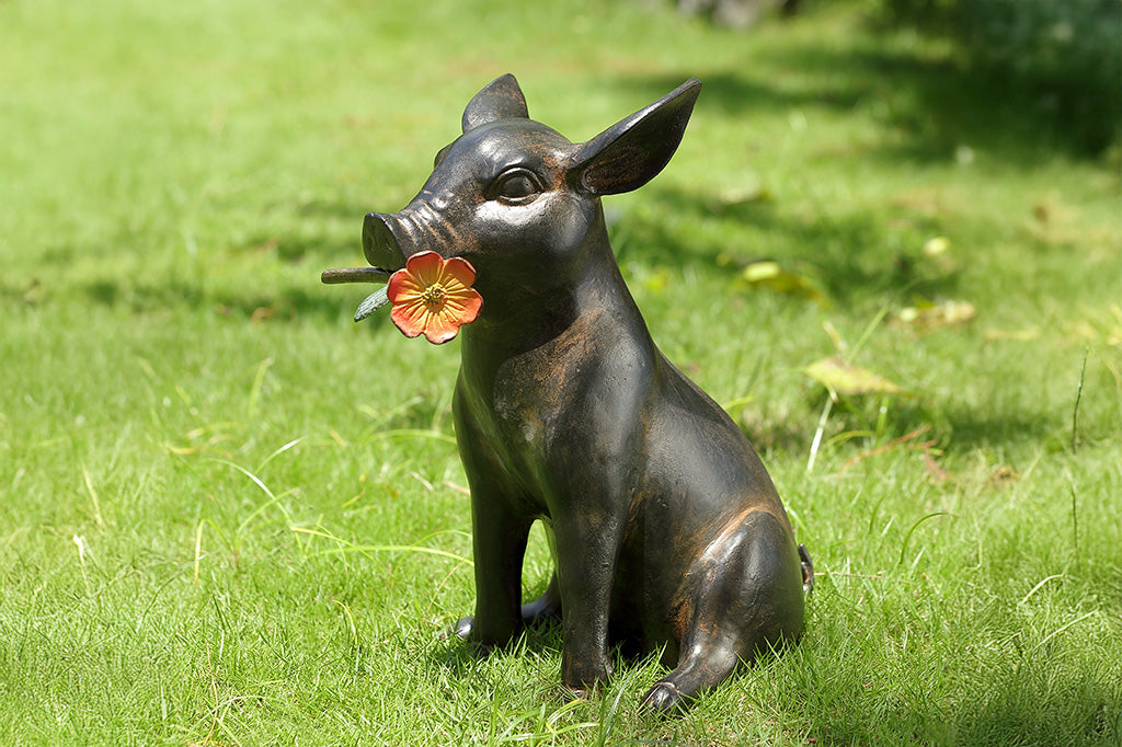 Pig sculpture with a flower in its mouth