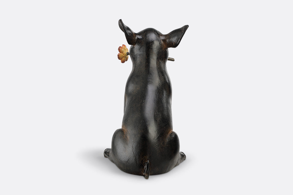 Pig sculpture with a flower in its mouth