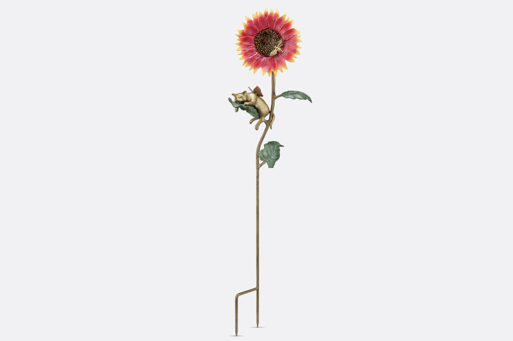 cast metal staked sunflower with cat napping on leaf garden sculpture, forked stake at bottom
