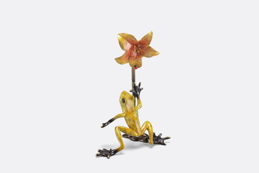 Frogs and flower figurine on a white background