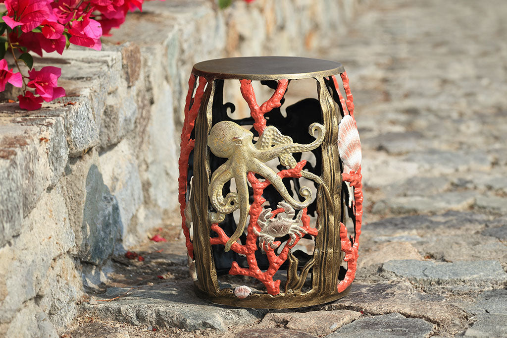 Decorative stool with octopus and coral design on a stone surface