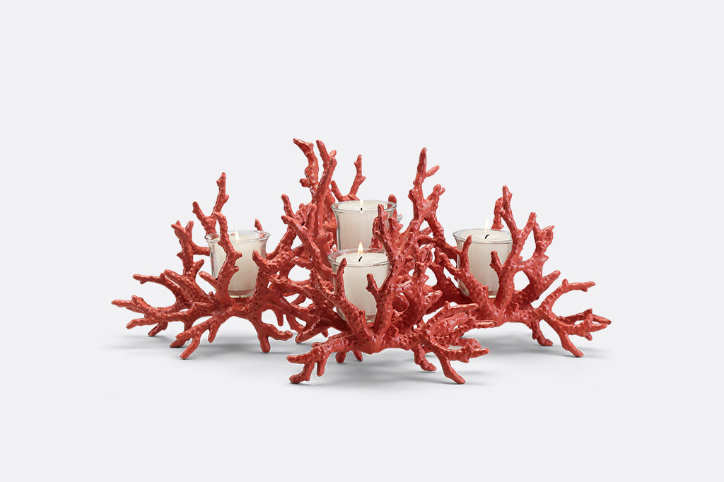 A candleholder in the shape of a pink coral reef that holds votive candles.