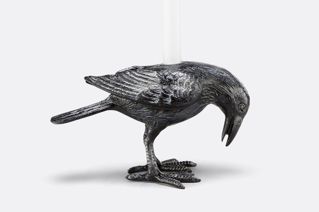 head-down raven taper candle holder on a white background