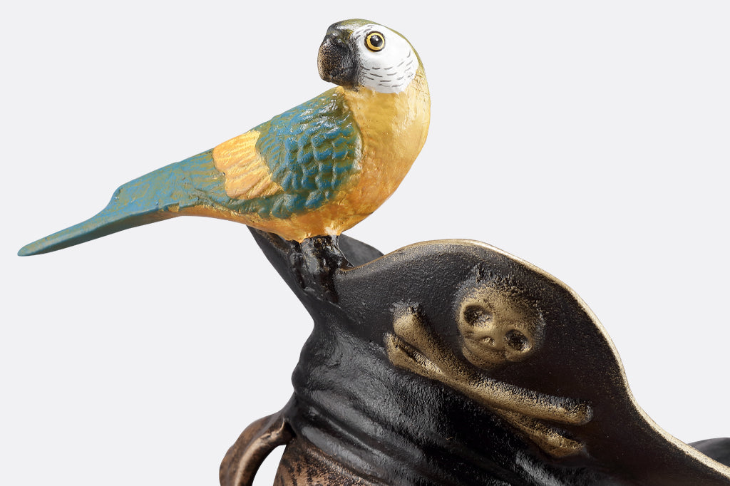 close up of yellow and blue parrot perched on pirate hat