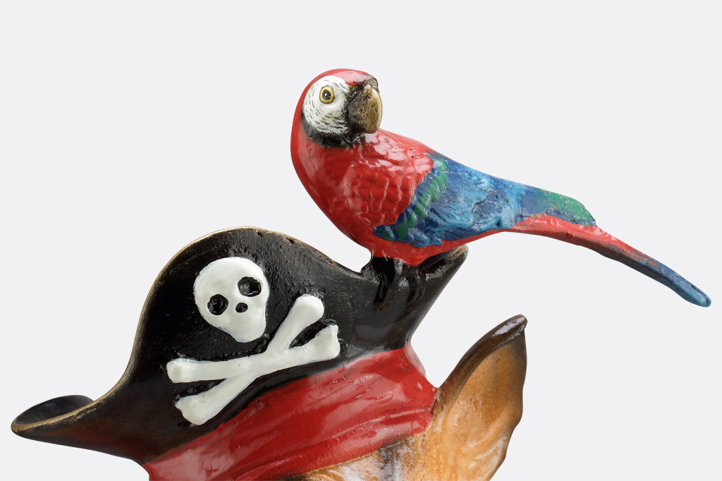 close up of red parrot perched on pirate hat