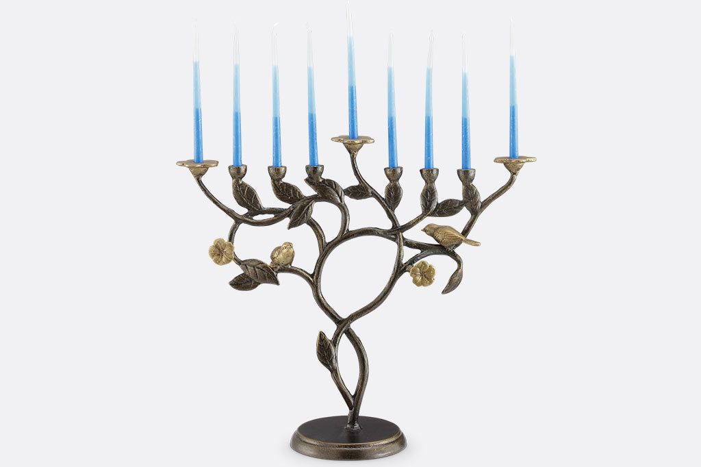 Decorative menorah with blue candles on a white background
