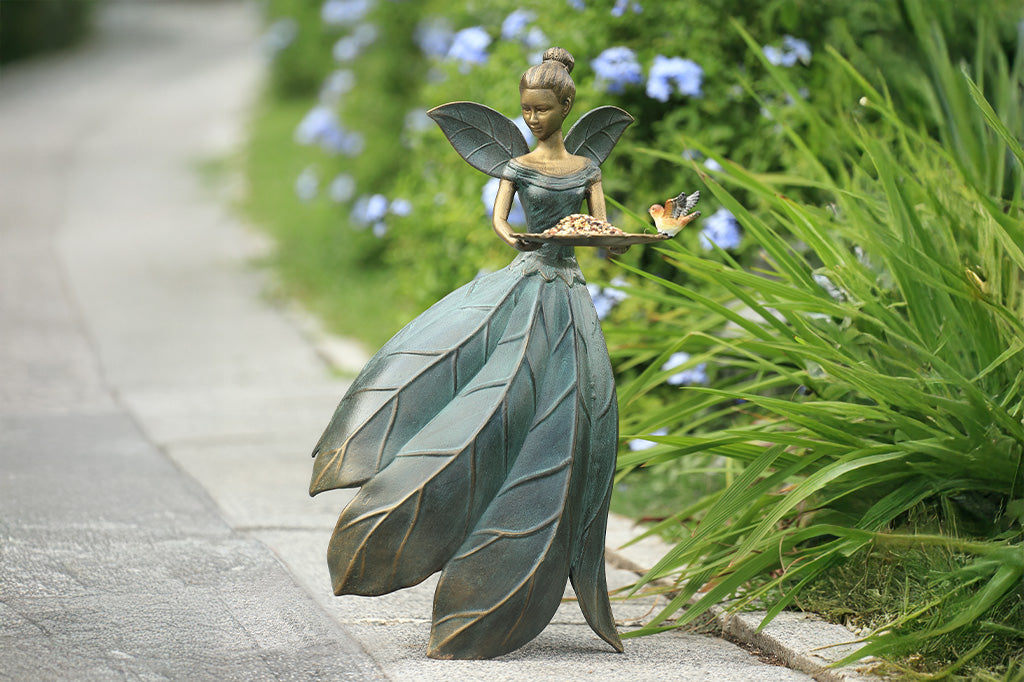 A hovering fairy with a flowing dress with a platter birdfeeder.