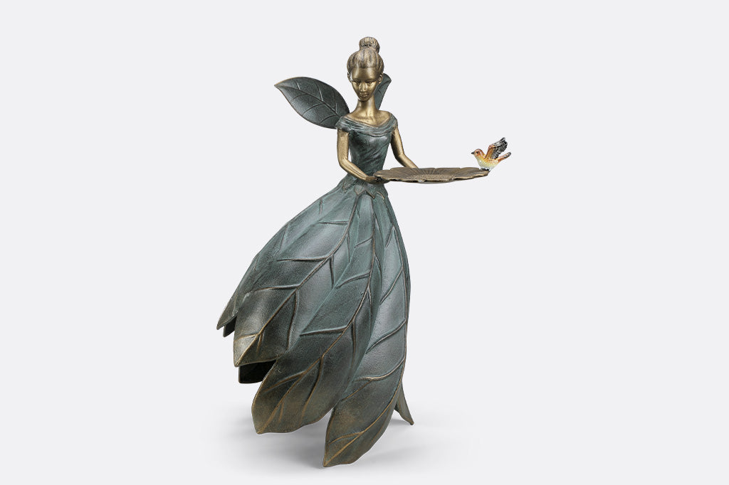 A hovering fairy with a flowing dress with a platter birdfeeder.