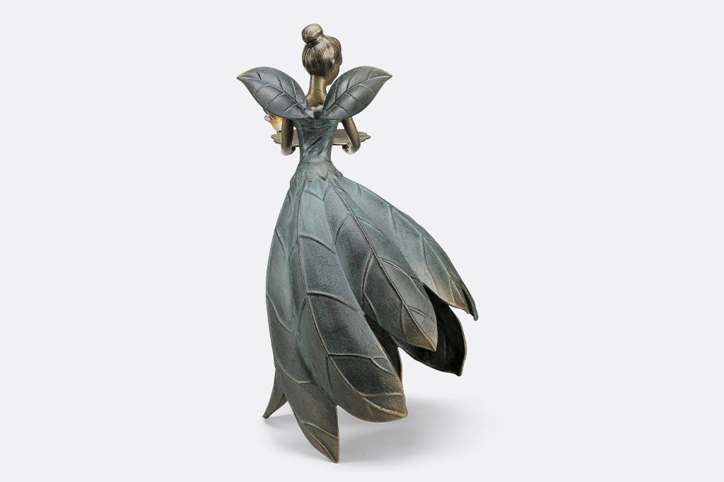 A hovering fairy with a flowing dress with a platter birdfeeder.