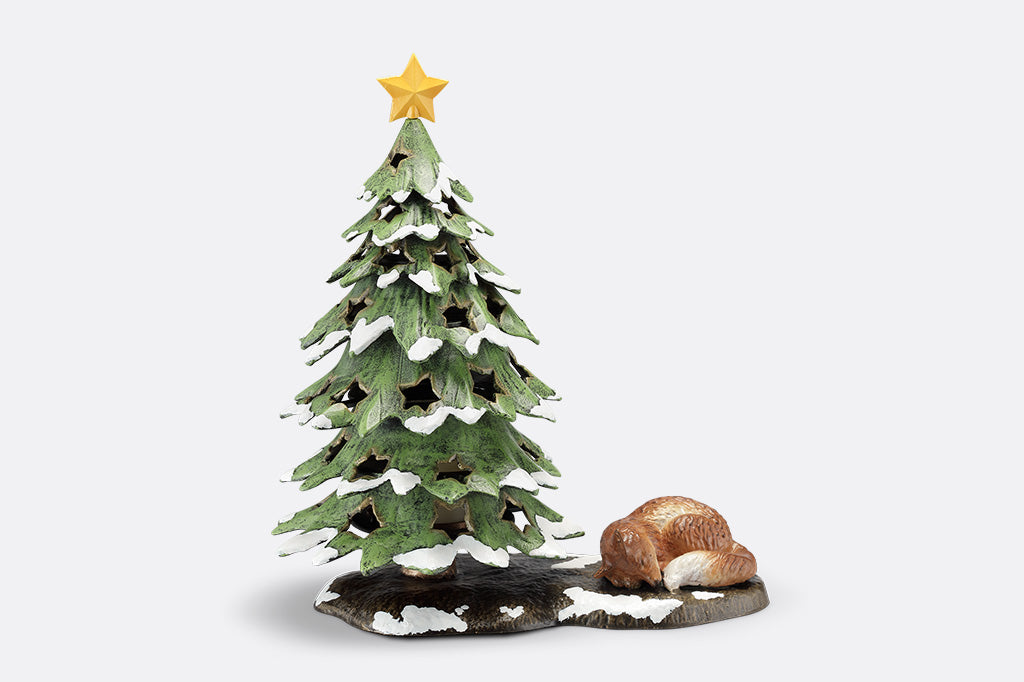 Decorative Christmas tree figurine with a star on top and a fox at its base on a white background
