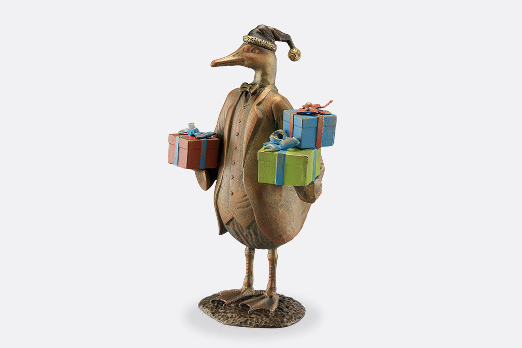 Decorative figurine of a bird holding gift boxes on a white background