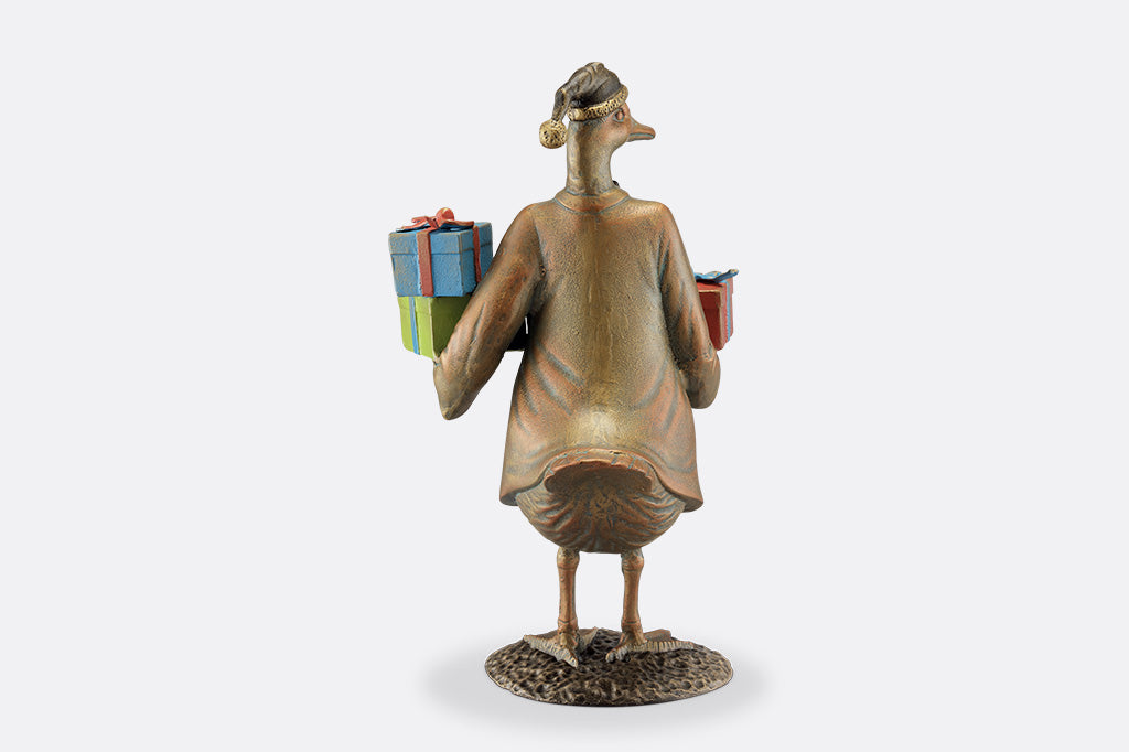 Decorative figurine of a bird holding gift boxes on a white background