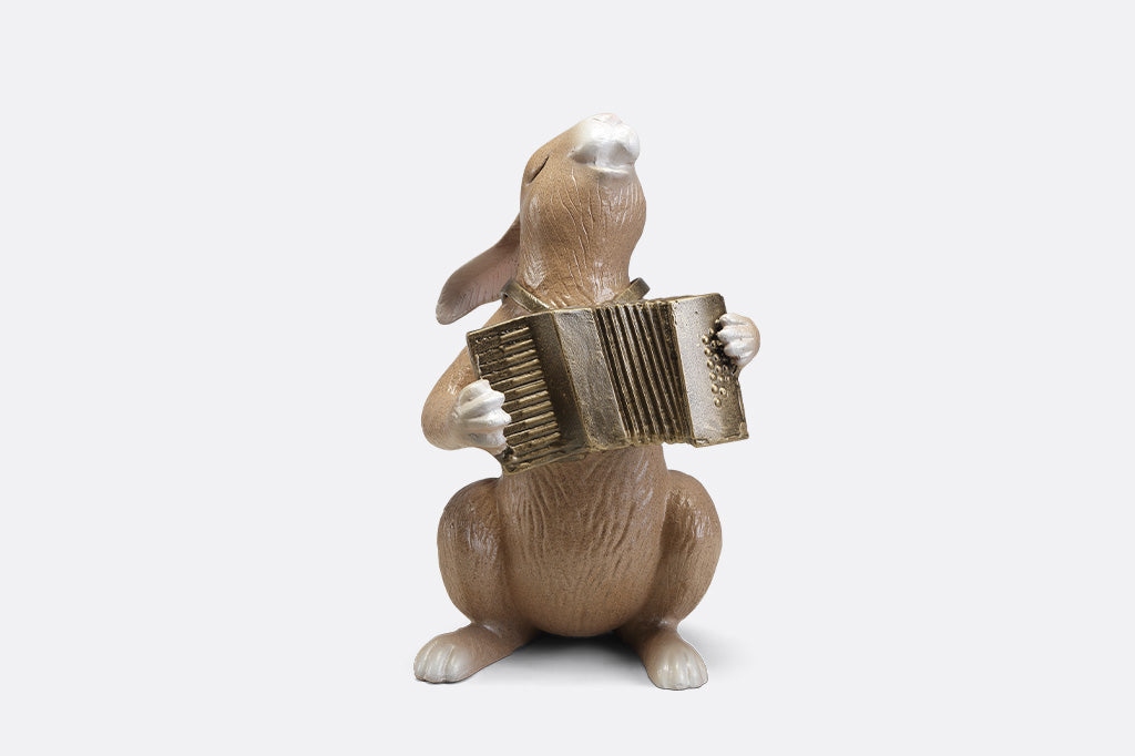 A sculpture of a bunny playing an accordion.