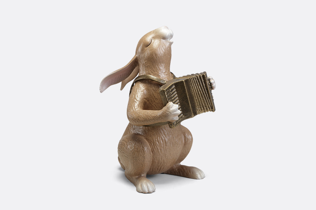 A sculpture of a bunny playing an accordion.