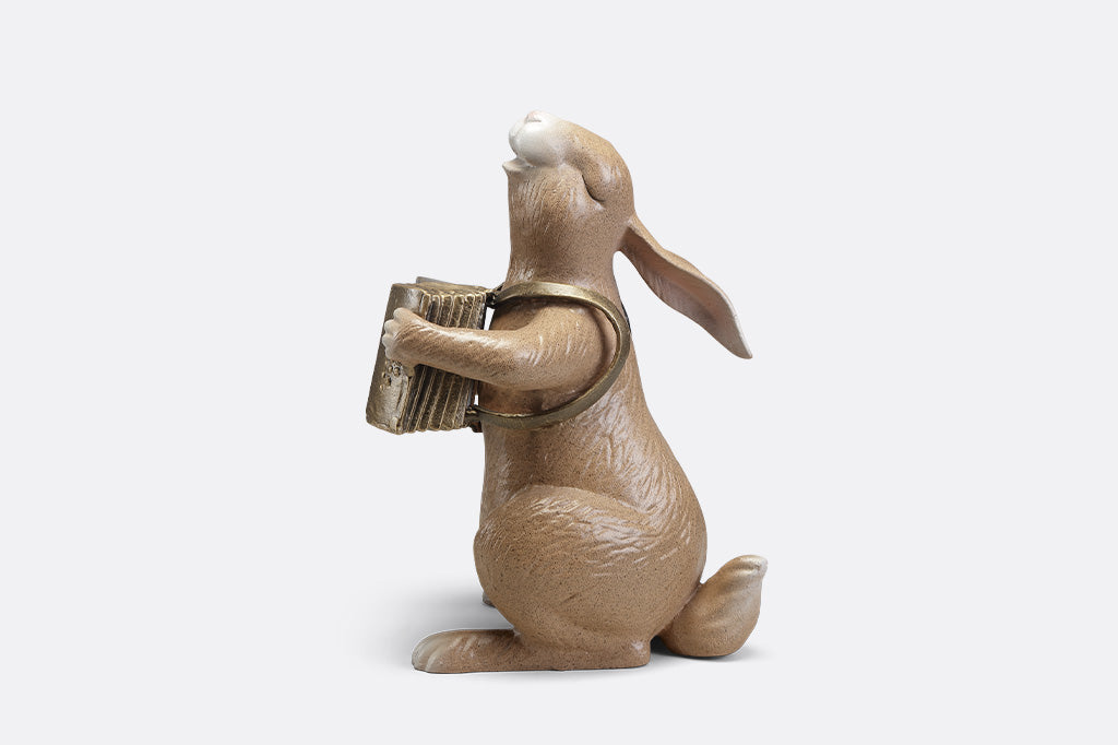 A sculpture of a bunny playing an accordion.
