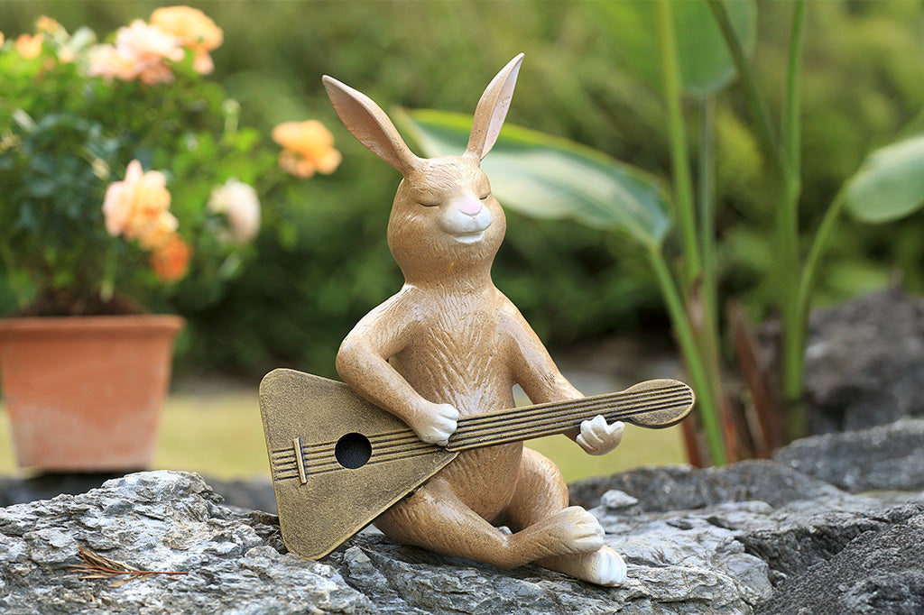 Sculpture of a bunny playing a guitar.