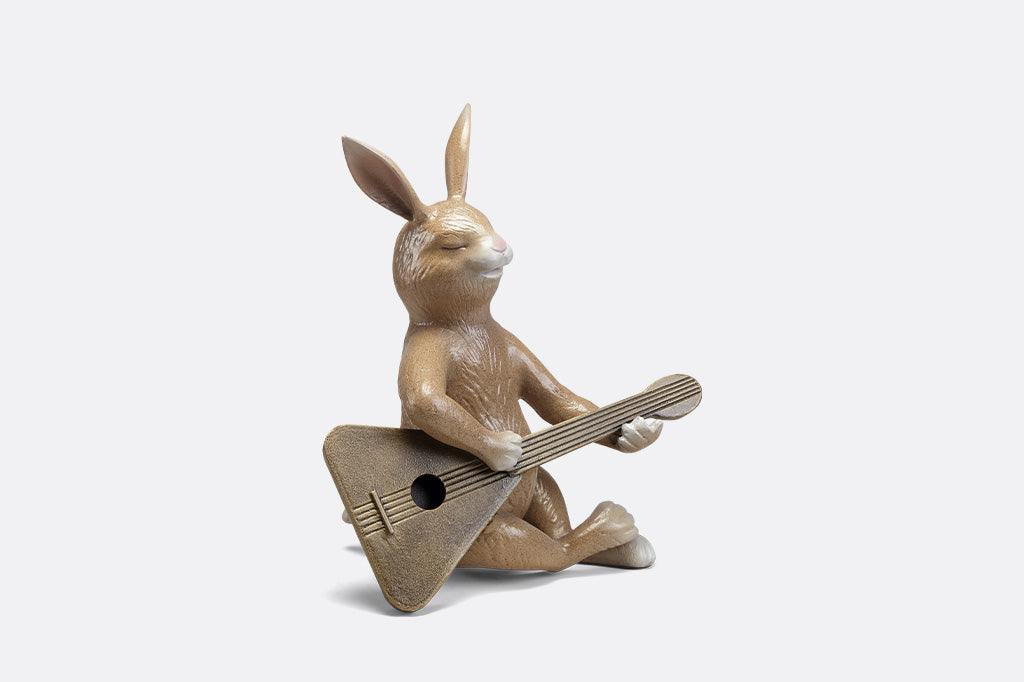 Sculpture of a bunny playing a guitar.