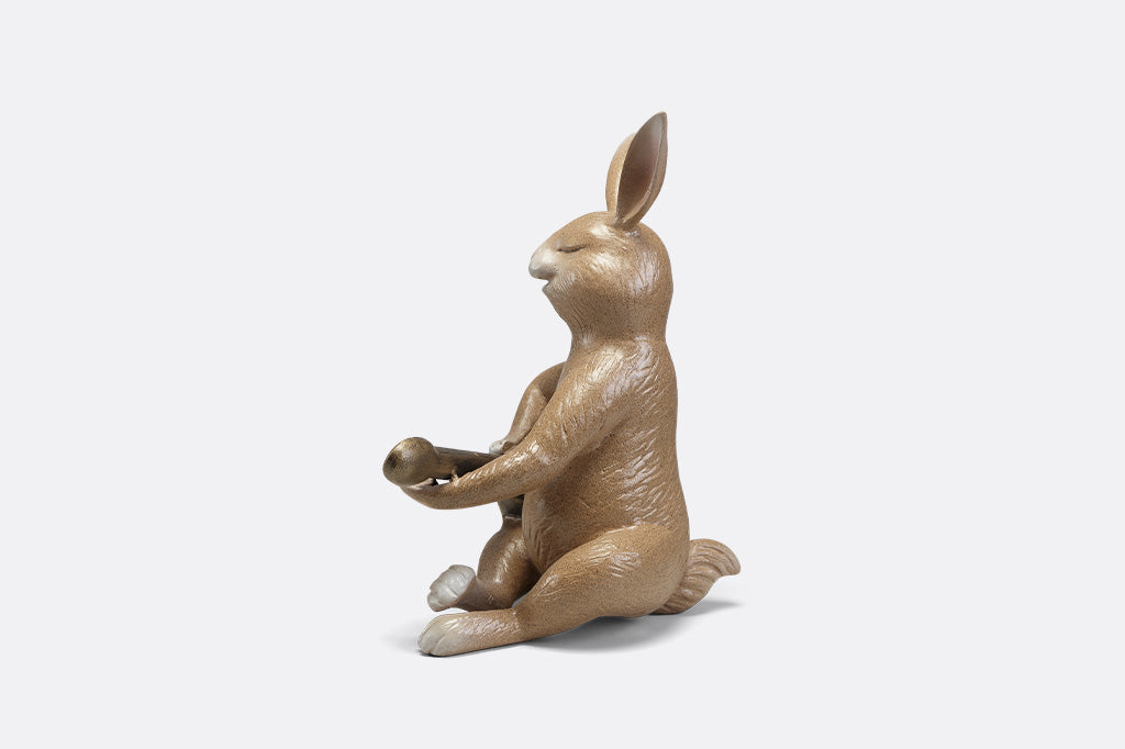 Sculpture of a bunny playing a guitar.