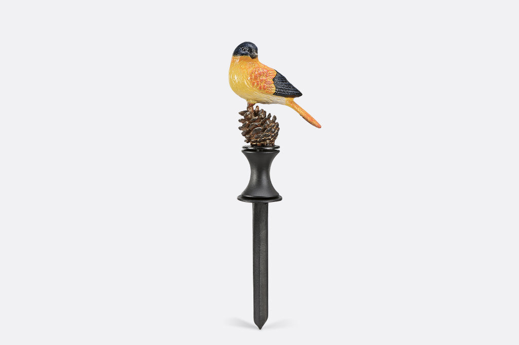Decorative garden stake with a bird and pine cone design on a white background