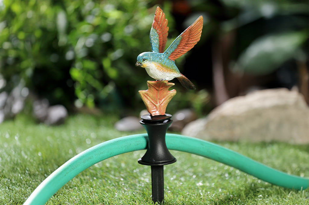 A hose guard of a bird landing upon a leaf.