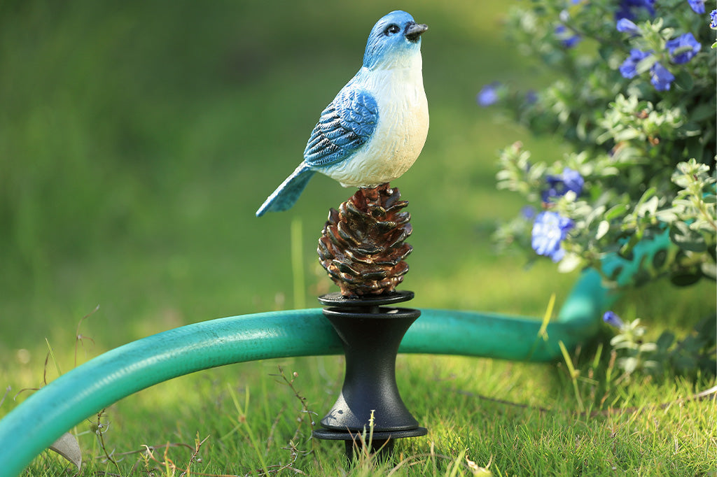 A blue bird on a pinecone hoseguard