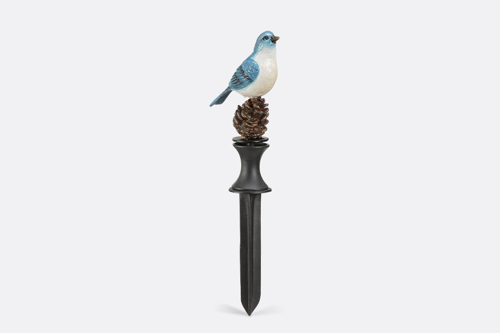 A blue bird on a pinecone hoseguard
