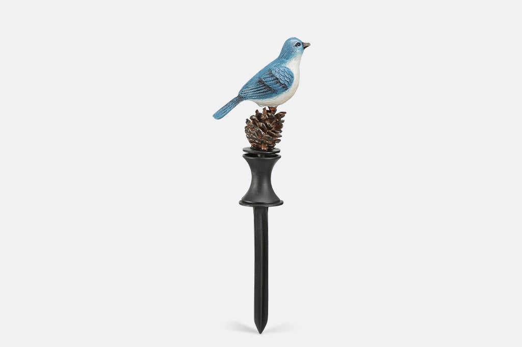 A blue bird on a pinecone hoseguard