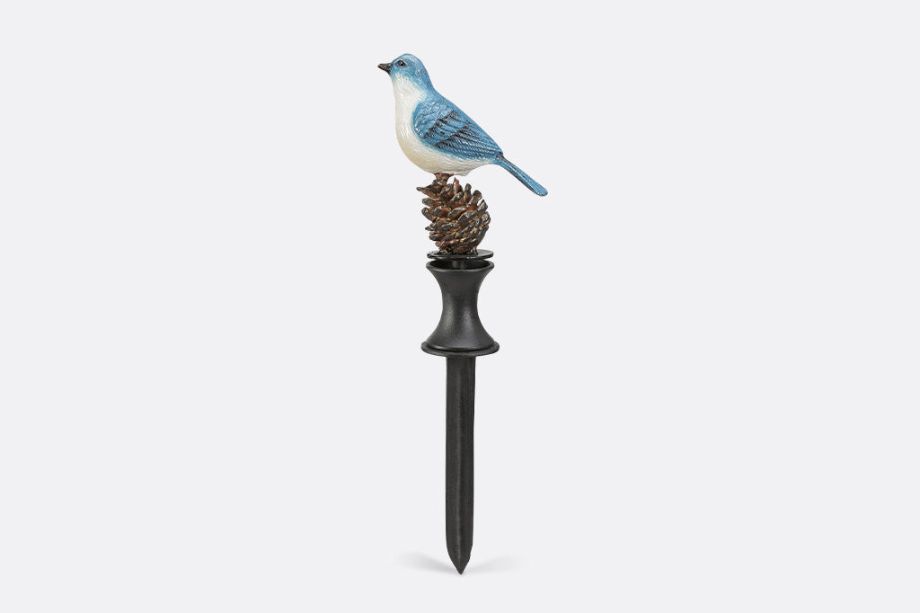 A blue bird on a pinecone hoseguard