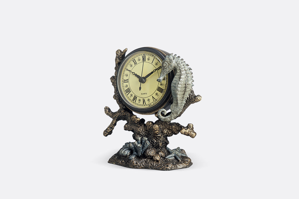 Clock with organic ocean like inspired design and a seahorse attached from side angle