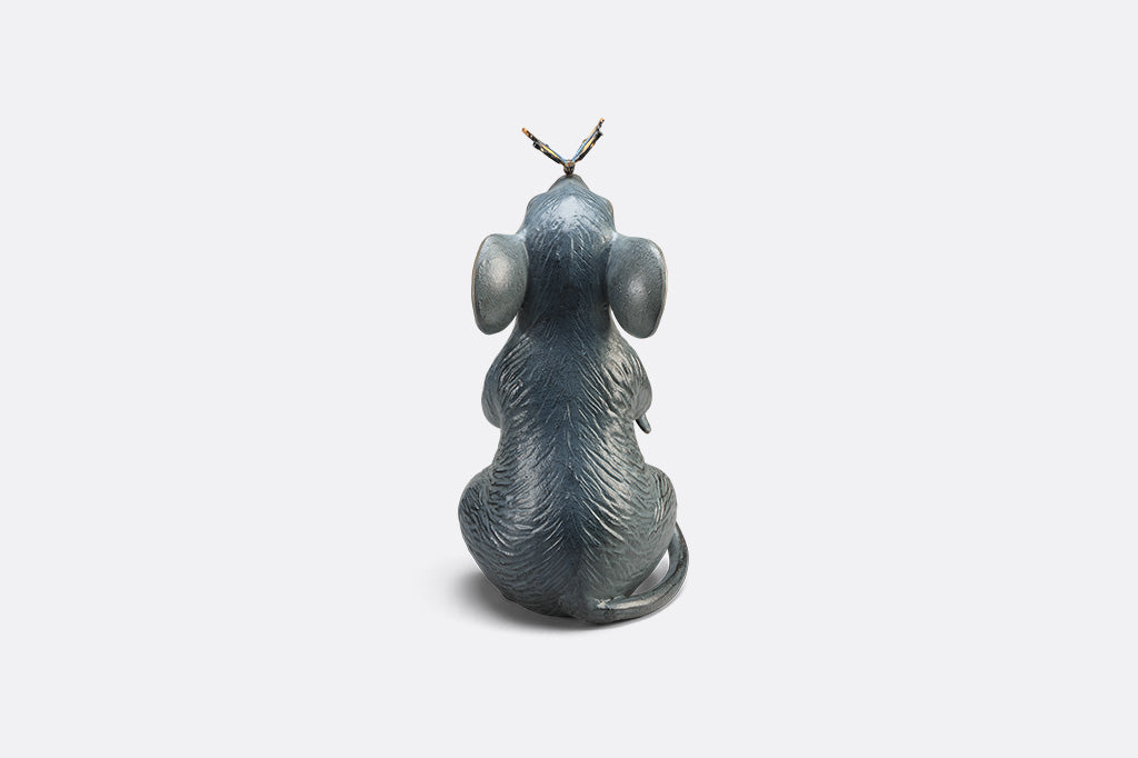 Statue of a mouse with a butterfly on its nose on white background