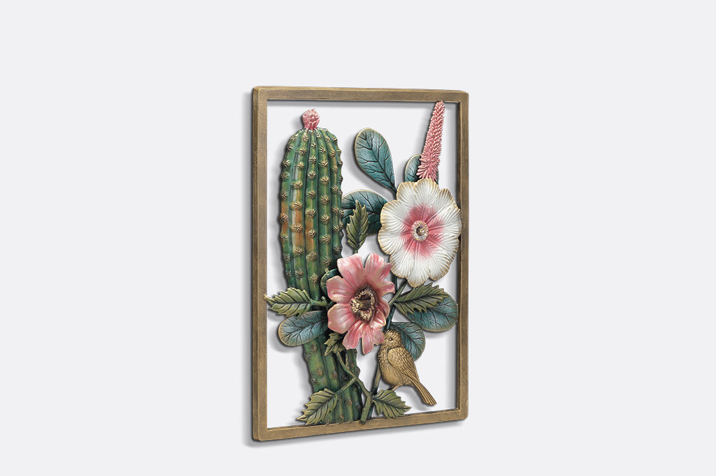A decorative wall art of a desert scene with cacti, flowers, and birds.