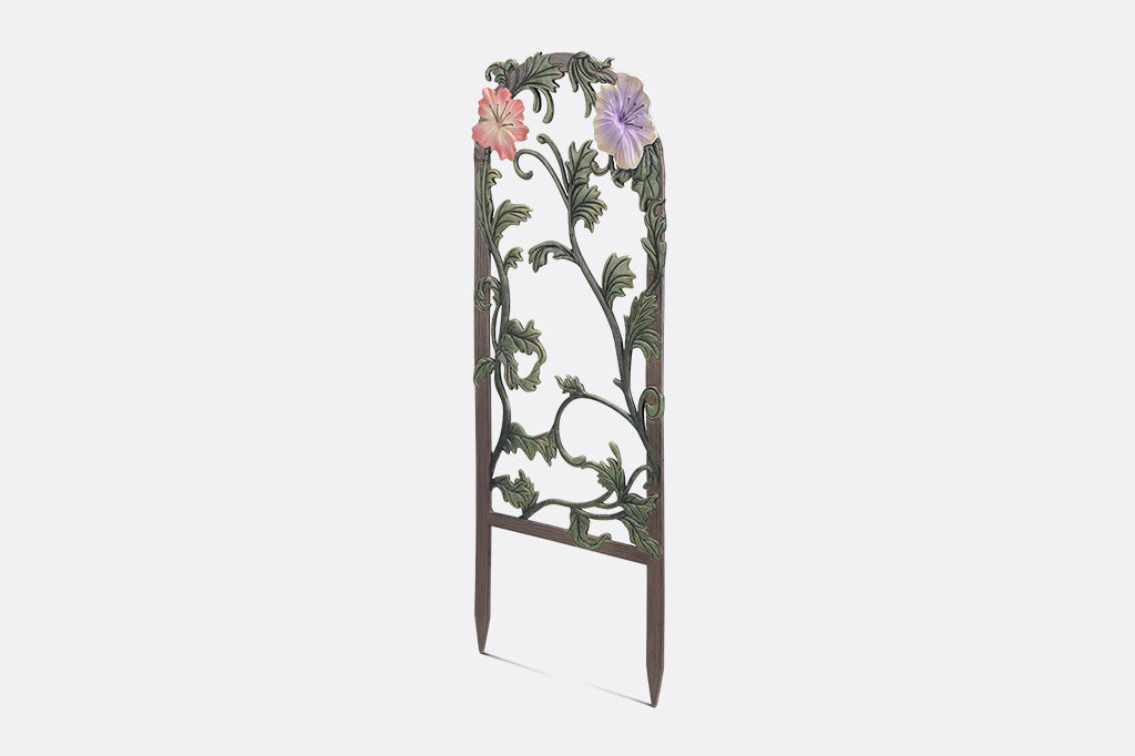 A decorative garden trellis featuring blooming lilies and branches.
