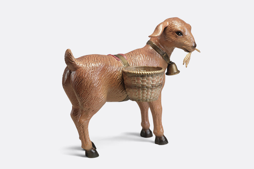 A planter sculpture of a goat with a bell carrying two baskets at his side.