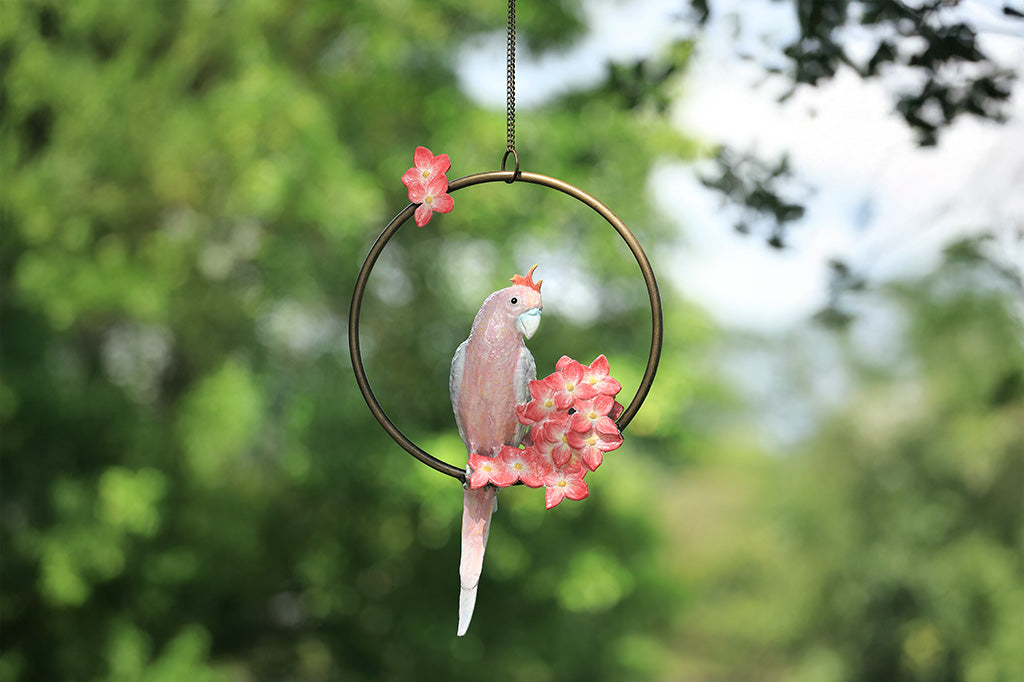 Decorative hanging sculpture with a bird and flowers