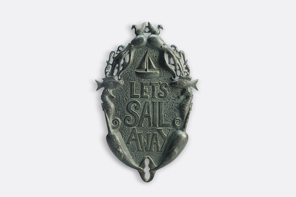 Decorative wall plaque with 'Let's Sail Away' text on a white background