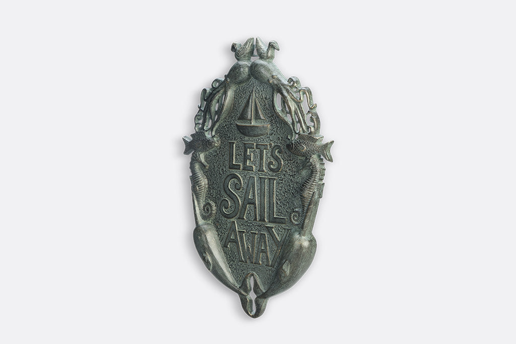 Decorative wall plaque with 'Let's Sail Away' text on a white background