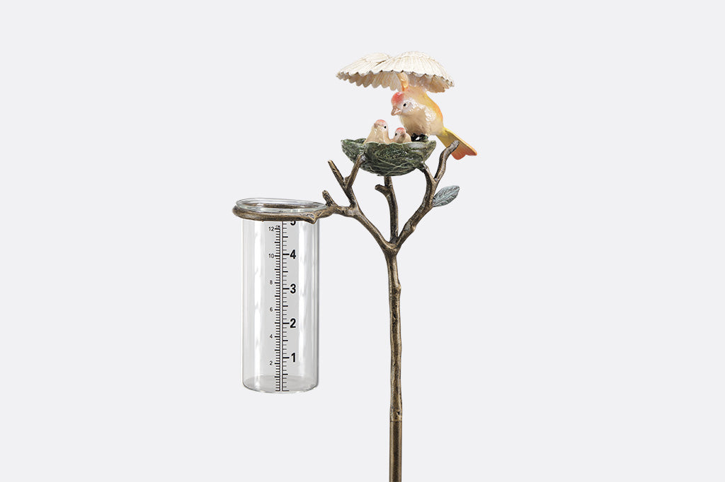 Decorative rain catcher with birds nest and birds on a white background
