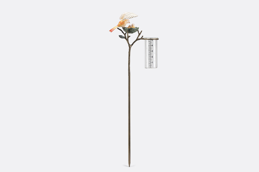 Decorative rain catcher with birds nest and birds on a white background