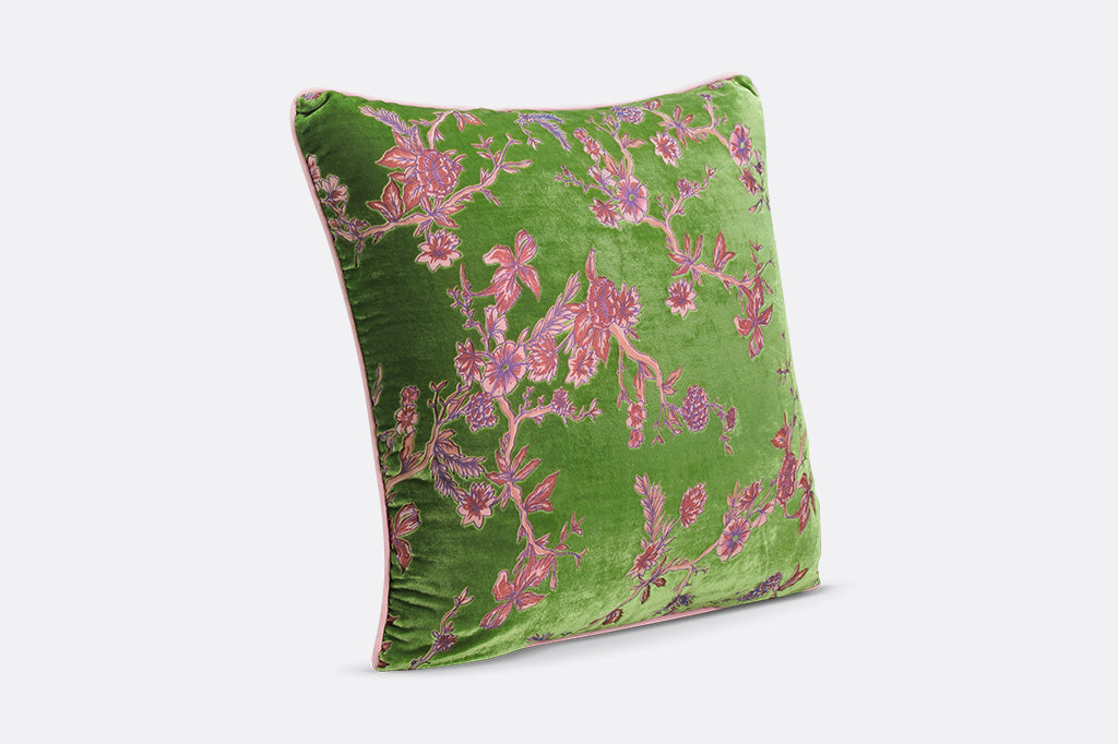 Green pillow with pink floral pattern