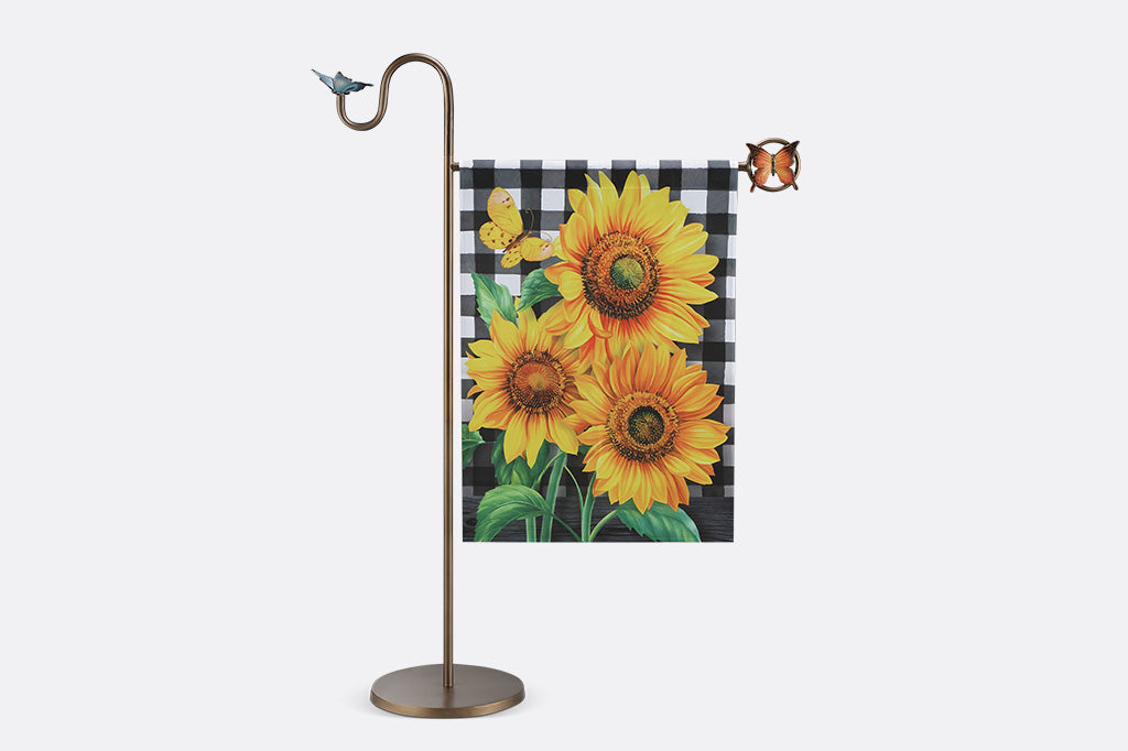 A flag stand with two butterflies and a flag with sunflowers