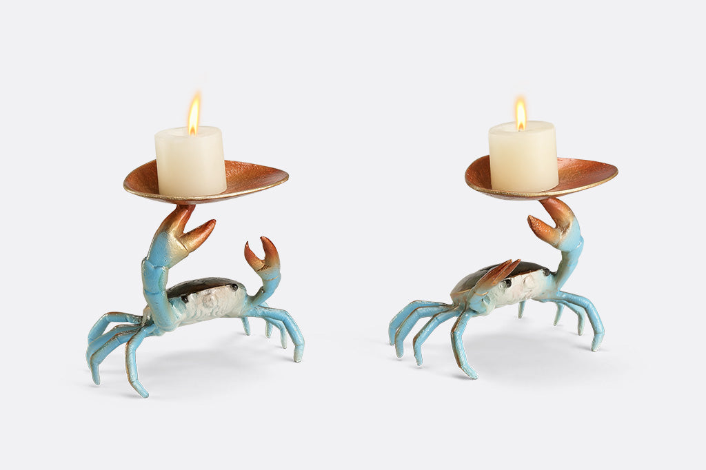 Two crab-shaped sculptures holding candles